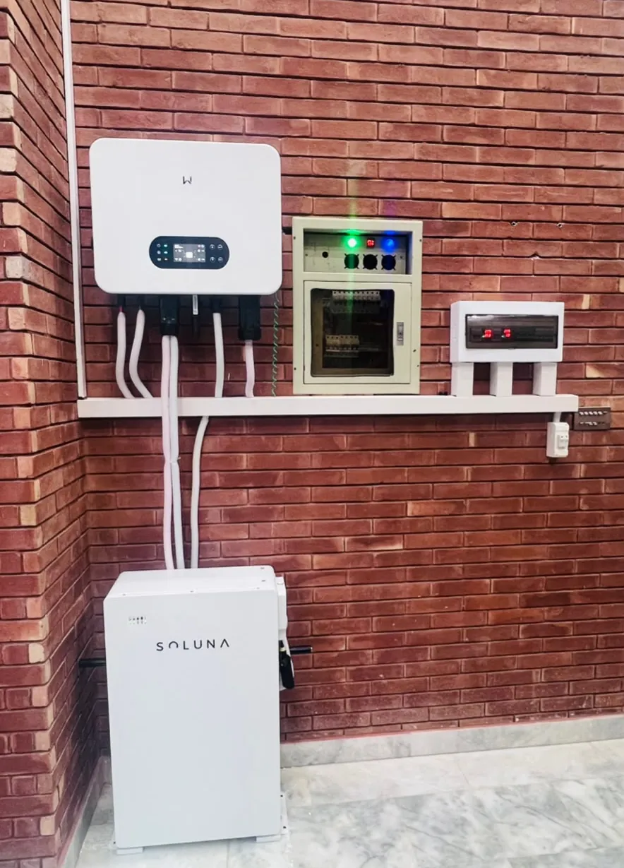 Hybrid inverter and Soluna battery installed by StenGrid on a brick wall at a home